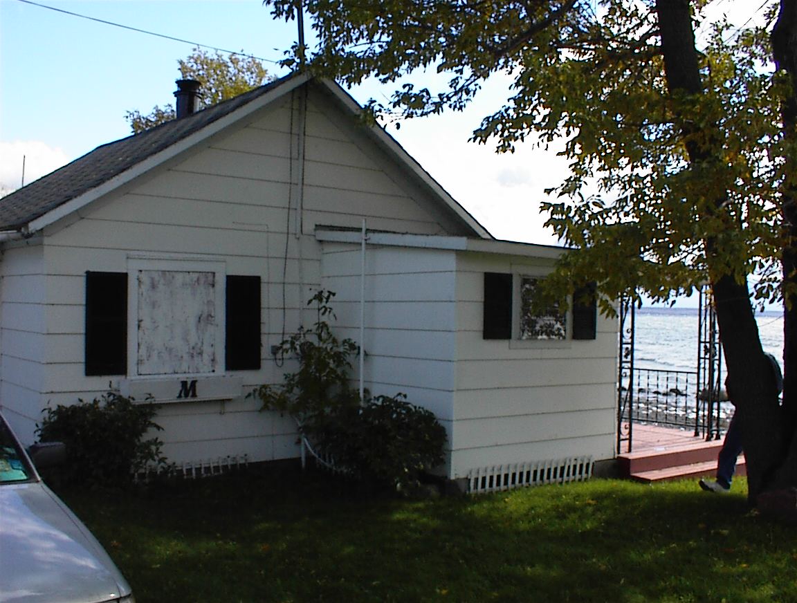 A house with a lake in the background

Description automatically generated