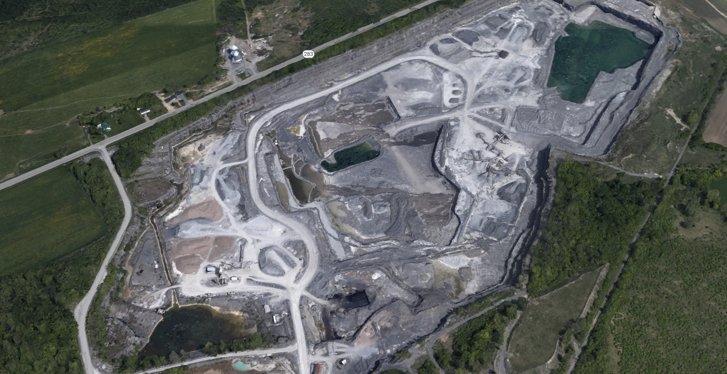 An aerial view of a quarry

Description automatically generated