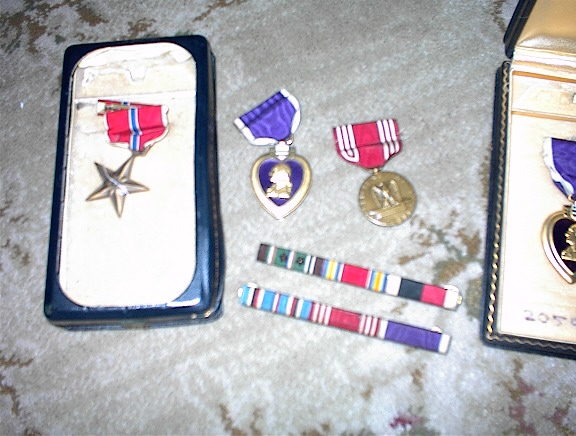 Several medals and a case

Description automatically generated