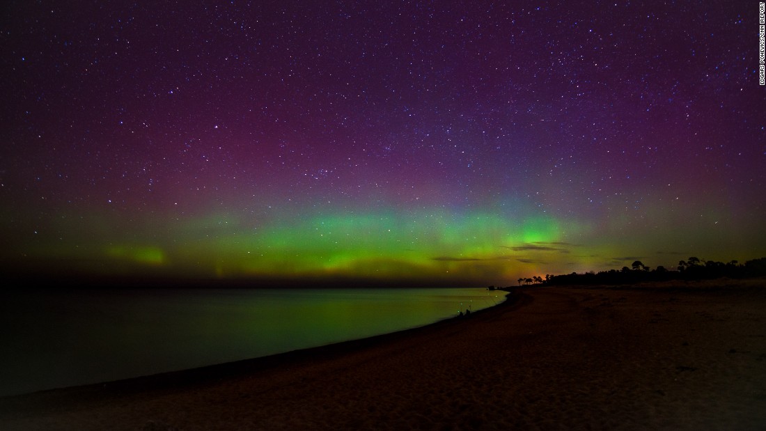 solar storm aurora over large city